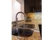 Close-up of the kitchen sink and backsplash with stainless steel faucet at 110 S Primrose Dr, Orlando, FL 32803