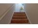 Carpeted stairway with white trim, leading to upper level at 110 S Primrose Dr, Orlando, FL 32803