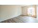 Bedroom features wood-look flooring, a closet, and a window with peach colored drapes at 1139 Humphrey Blvd, Deltona, FL 32738