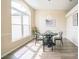 Bright dining area with hardwood floors, a dark wood table set for four, and a large window at 1139 Humphrey Blvd, Deltona, FL 32738