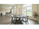 Bright dining area with hardwood floors, a dark wood table set for four, and plenty of natural light at 1139 Humphrey Blvd, Deltona, FL 32738