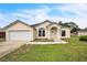 Charming single-story home featuring a well-maintained lawn, neutral colors, and an attached two-car garage at 1139 Humphrey Blvd, Deltona, FL 32738