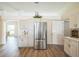 Bright kitchen with stainless steel fridge and light cabinets and a serving counter at 1139 Humphrey Blvd, Deltona, FL 32738
