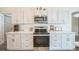 Kitchen featuring white cabinets, stainless appliances, and ample counter space at 1139 Humphrey Blvd, Deltona, FL 32738