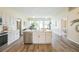 Bright kitchen features white cabinets, an island with a sink, and stainless appliances at 1139 Humphrey Blvd, Deltona, FL 32738