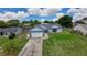 An elevated view showing a well-manicured lawn, a driveway, and mature trees surrounding the property at 119 Ridgecrest Dr, Eustis, FL 32726