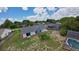An aerial view showing a backyard with mature trees and residential surroundings at 119 Ridgecrest Dr, Eustis, FL 32726