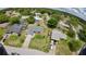 An aerial view showcasing a residential area with well-maintained lawns, mature trees, and lovely landscaping at 119 Ridgecrest Dr, Eustis, FL 32726