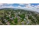 An expansive aerial view showing a quiet neighborhood surrounded by mature trees and serene lake at 119 Ridgecrest Dr, Eustis, FL 32726