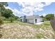 There is a view of the home's backyard with a green lawn and a fireplace at 119 Ridgecrest Dr, Eustis, FL 32726