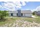 The backyard has a fireplace and is spacious with green grass at 119 Ridgecrest Dr, Eustis, FL 32726