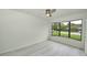 Bright bedroom with wood-look floors, large window, and natural light at 119 Ridgecrest Dr, Eustis, FL 32726