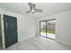 Bright bedroom with a ceiling fan, wood-look floors, and sliding glass door at 119 Ridgecrest Dr, Eustis, FL 32726