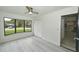 Bright bedroom with wood-look floors, large window, and closet at 119 Ridgecrest Dr, Eustis, FL 32726