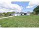 Charming single-story home with well-manicured lawn, neutral paint, and an attached garage at 119 Ridgecrest Dr, Eustis, FL 32726