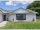Beautiful home featuring a garden with decorative rocks and lush green grass at 119 Ridgecrest Dr, Eustis, FL 32726
