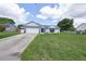 A well-maintained home featuring an attached garage, and a manicured lawn at 119 Ridgecrest Dr, Eustis, FL 32726