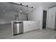 Bright kitchen featuring shaker cabinets, stainless steel appliances, and modern pendant lighting at 119 Ridgecrest Dr, Eustis, FL 32726