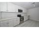 Modern kitchen featuring stainless steel appliances, white cabinets, and quartz countertops at 119 Ridgecrest Dr, Eustis, FL 32726