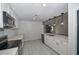 Well-designed kitchen with stainless appliances, quartz counters, and pendant lights at 119 Ridgecrest Dr, Eustis, FL 32726