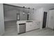 Bright kitchen featuring shaker cabinets, stainless steel appliances, and modern pendant lighting at 119 Ridgecrest Dr, Eustis, FL 32726