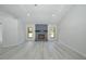 Inviting living room with brick fireplace, windows, and sleek light wood-look floors at 119 Ridgecrest Dr, Eustis, FL 32726