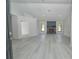 Bright and open living room with light grey laminate flooring and a brick fireplace at 119 Ridgecrest Dr, Eustis, FL 32726