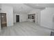 Spacious living room featuring light wood flooring and an open floor plan to the modern kitchen at 119 Ridgecrest Dr, Eustis, FL 32726