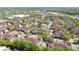 Scenic aerial view of a community featuring beautiful landscaping and a serene pond at 12107 Poppy Field Ln # 105, Orlando, FL 32837
