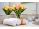 Bathroom countertop featuring a vase of flowers, rolled towels, and a decorative candle at 12107 Poppy Field Ln # 105, Orlando, FL 32837