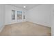 Spacious bedroom with three windows providing ample natural light and neutral carpeting at 12107 Poppy Field Ln # 105, Orlando, FL 32837