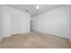 Large bedroom with neutral carpeting, ample natural light, and closet with shelving at 12107 Poppy Field Ln # 105, Orlando, FL 32837