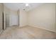 Spacious carpeted bedroom with neutral tones and a door to an en-suite bath at 12107 Poppy Field Ln # 105, Orlando, FL 32837
