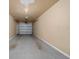 A well-lit, two-car garage featuring a durable concrete floor and ample space for vehicles and storage at 12107 Poppy Field Ln # 105, Orlando, FL 32837