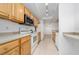 Traditional kitchen with stainless steel appliances, wood cabinets, and tile flooring at 12107 Poppy Field Ln # 105, Orlando, FL 32837