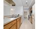 Traditional kitchen with stainless steel sink, wood cabinets, and white appliances at 12107 Poppy Field Ln # 105, Orlando, FL 32837