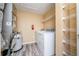 Utility room with washer, dryer, hot water tank, and utility shelving at 12107 Poppy Field Ln # 105, Orlando, FL 32837