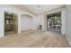 Large living room with neutral carpet, alcove, and sliding glass door to the screened balcony at 12107 Poppy Field Ln # 105, Orlando, FL 32837