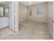 Well-lit main bedroom with neutral tones, carpet, en-suite bath, and natural light at 12107 Poppy Field Ln # 105, Orlando, FL 32837