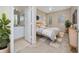 Well-lit main bedroom featuring neutral tones, carpet flooring, and en-suite bath at 12107 Poppy Field Ln # 105, Orlando, FL 32837