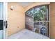 Screened in porch with view of trees and a parking area at 12107 Poppy Field Ln # 105, Orlando, FL 32837