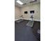 Community exercise room with two treadmills and two wall mounted televisions at 1325 Rotonda Pt # 117, Lake Mary, FL 32746