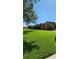 Exterior view of an apartment building with lush green lawn and trees, showcasing a peaceful residential setting at 1325 Rotonda Pt # 117, Lake Mary, FL 32746