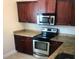 Contemporary kitchen with stainless steel microwave and granite counters at 1325 Rotonda Pt # 117, Lake Mary, FL 32746