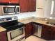 Modern kitchen featuring stainless steel appliances and granite countertops at 1325 Rotonda Pt # 117, Lake Mary, FL 32746