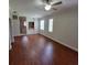 Spacious living room featuring wood floors, a ceiling fan, and ample natural light at 1325 Rotonda Pt # 117, Lake Mary, FL 32746