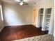 Spacious living room with hardwood floors, ceiling fan, and built-in shelving at 1325 Rotonda Pt # 117, Lake Mary, FL 32746