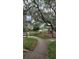 Park scene with walking path, playground, and benches under mossy trees, offering a peaceful recreational space at 1325 Rotonda Pt # 117, Lake Mary, FL 32746