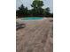 A clean pool surrounded by lounge chairs on brick surface, inviting residents to enjoy sunbathing at 1325 Rotonda Pt # 117, Lake Mary, FL 32746