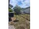 A partially fenced backyard with satellite dish and AC unit at 138 Maple Dr, Debary, FL 32713